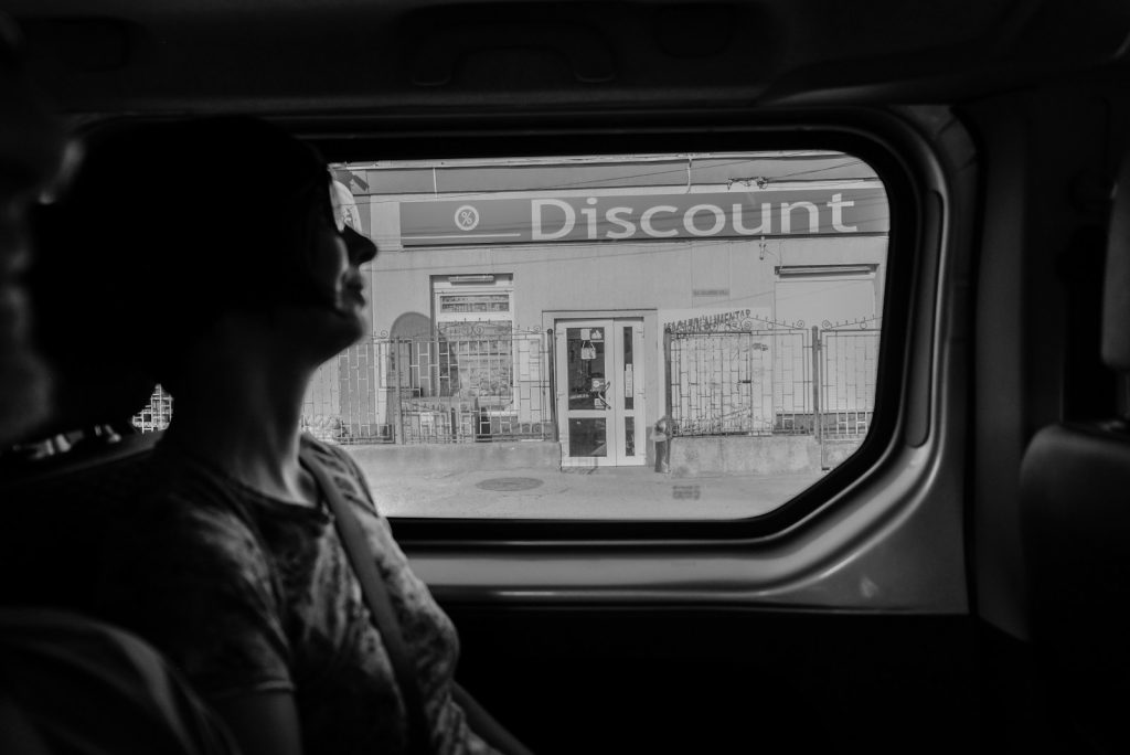 View from a car of a store with a discount sign