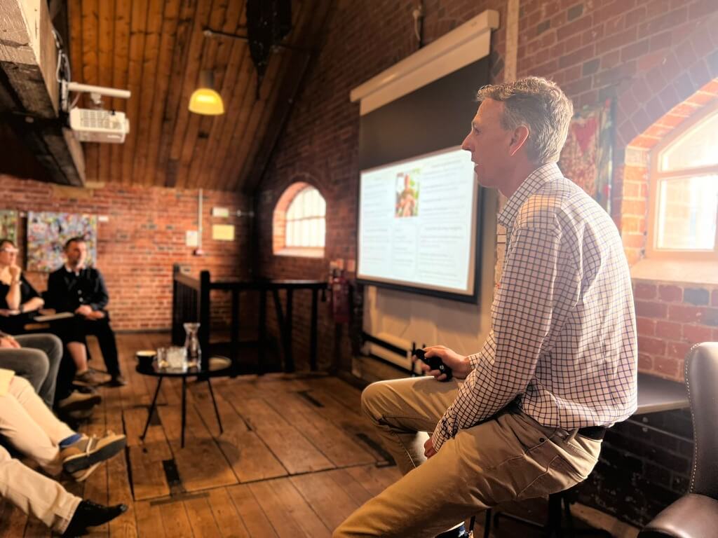 Justin Presenting value pricing and customer experience to a group of business owners at the Old Bond Store in Southampton