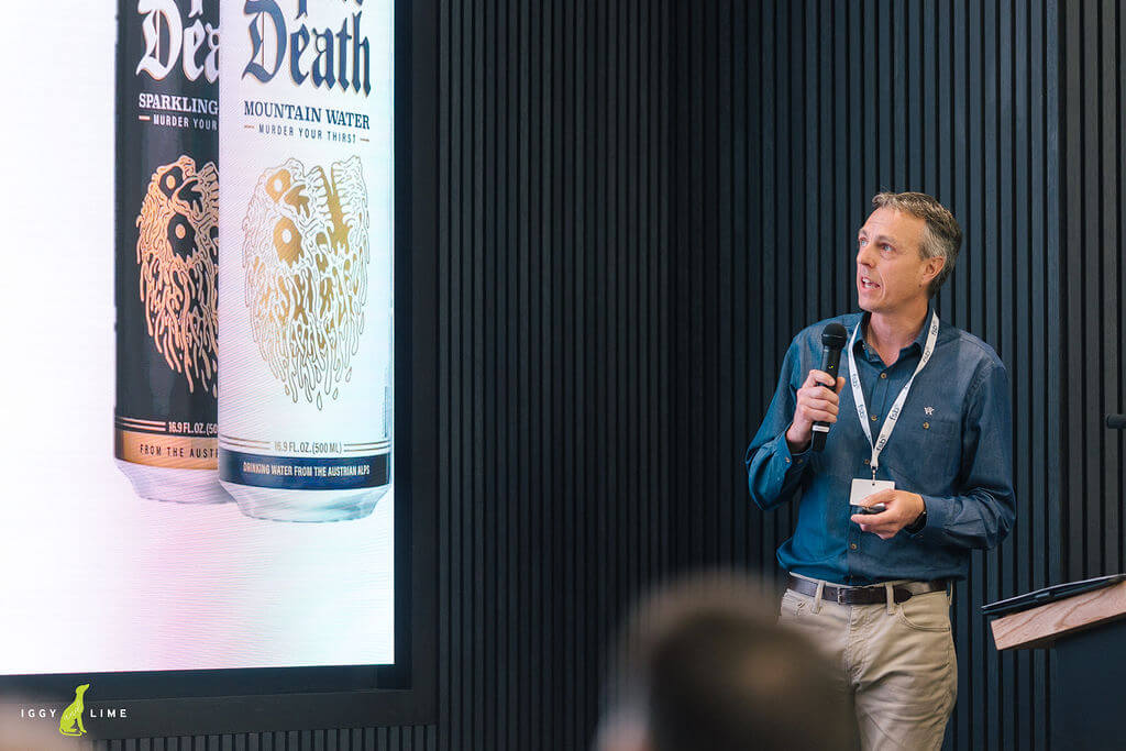 Justin Neale on stage presenting the story of Liquid Death and how the brand became into being